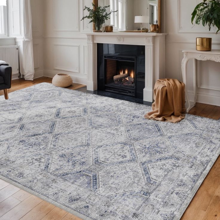 a living room with a fireplace and rug