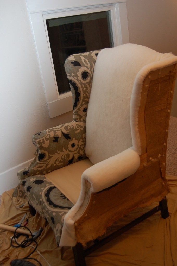 a chair that has been upholstered and is sitting in front of a window