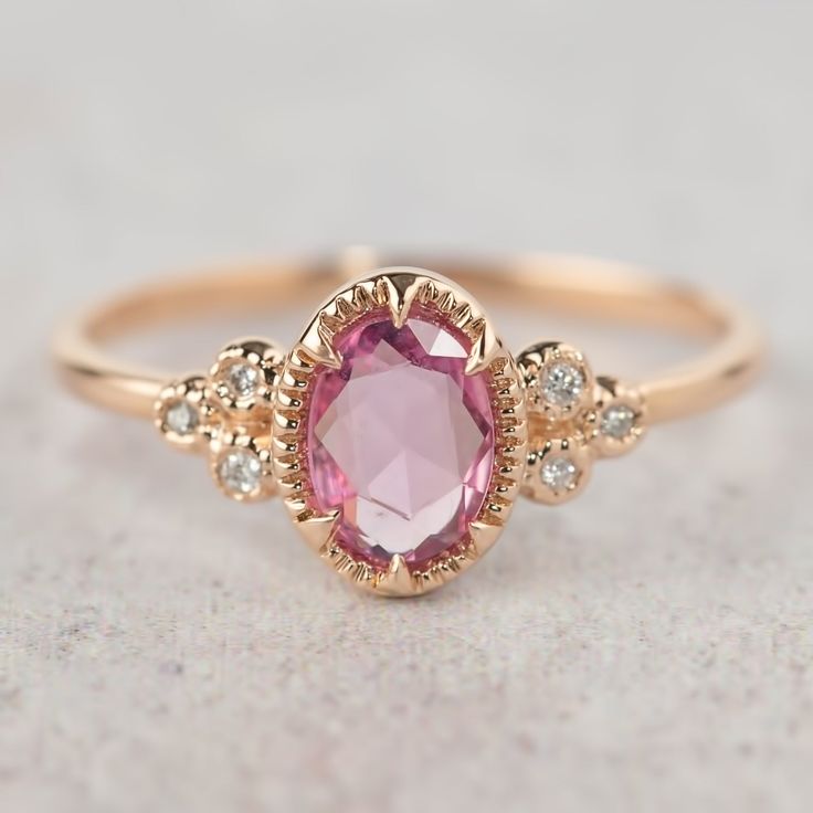 a close up view of a pink ring with diamonds