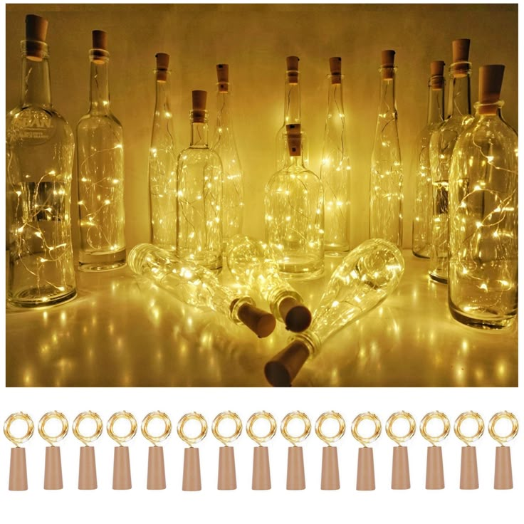 several bottles with lights in them sitting on a table