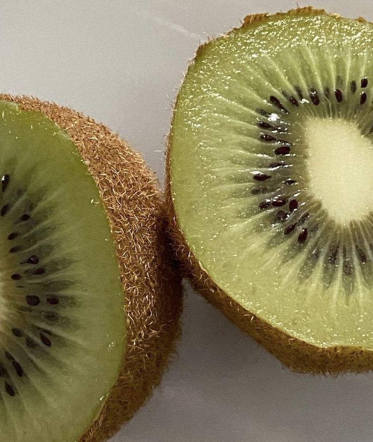 the kiwi is cut in half and ready to be eaten