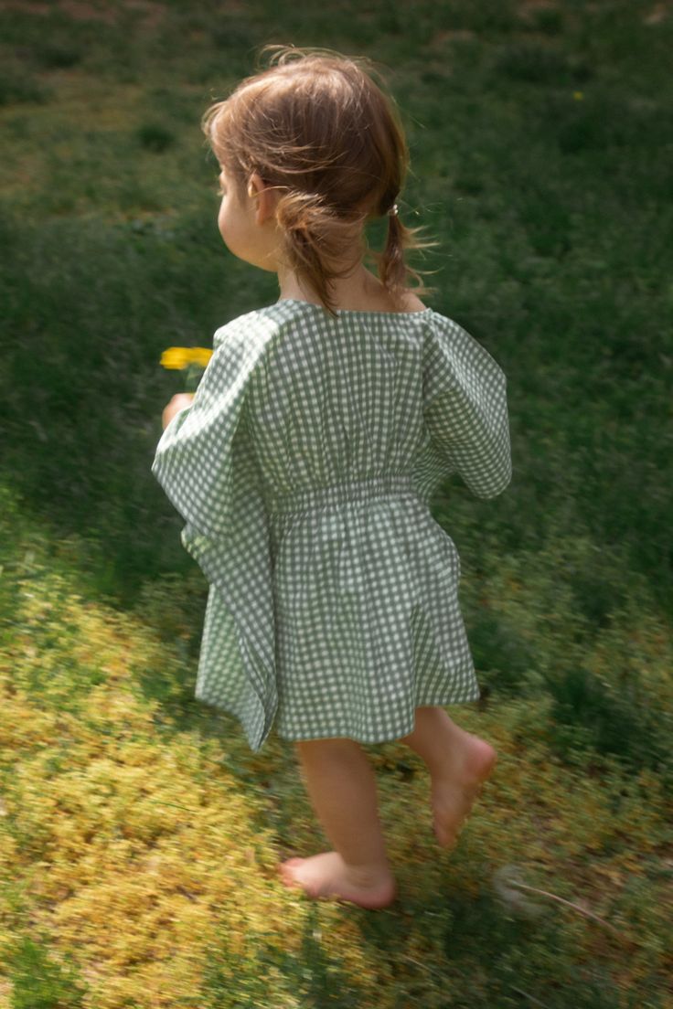 A matching caftan for your mini. Our signature block-printed gingham has been applied by hand using natural dyes to the finest organic cotton for a designer frock she'll be able to wear for years to come, thanks to our flexible sizing. The Bella Caftan is a multi-purpose toddler dress suitable for everything from afternoon play dates to birthday parties or brunch with the fam. Behind the name: "My Aunt Sandy has always called me Bella, short for Sarah-Bella, and I've passed this nickname on to m Bohemian Cotton Dress For Picnic, Cotton Dresses For Fall Gatherings, Fall Cotton Dress For Gatherings, Cotton Dress For Gatherings In Fall, Spring Cotton Dresses For Gatherings, Cotton Smock Dress For Picnic, Cotton Dresses For Spring Gatherings, Long Sleeve Gingham Dress For Picnic, Peasant Style Cotton Dress For Gatherings