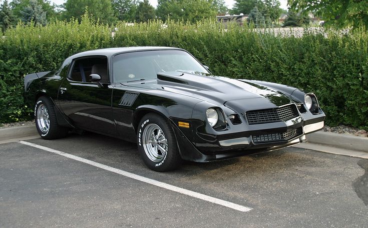 a black sports car parked in a parking lot