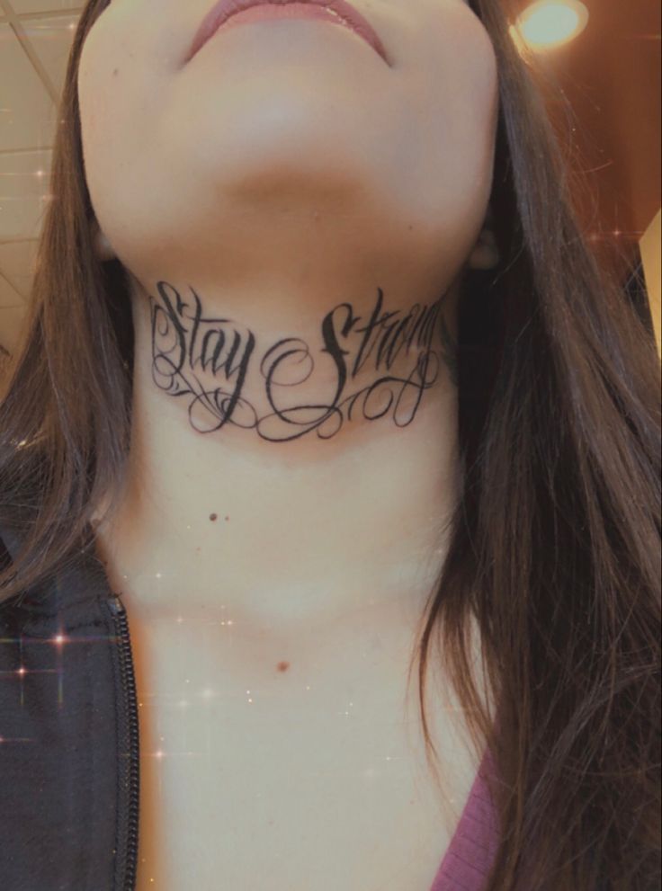 a woman's neck with the words stay strong tattooed on her upper part and lower part