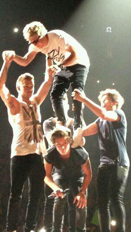 a group of young men standing on top of each other