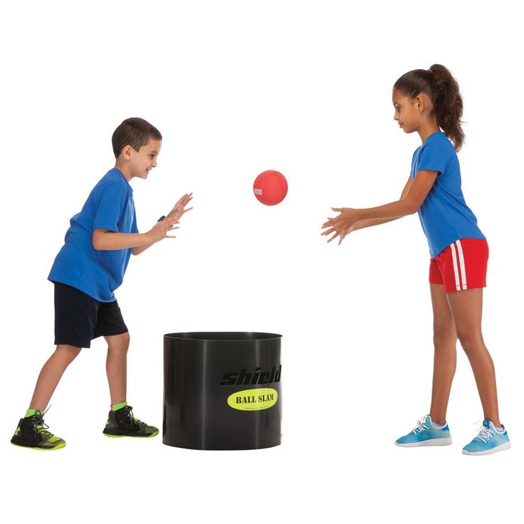 two children are playing with a ball in front of a black trash can on a white background