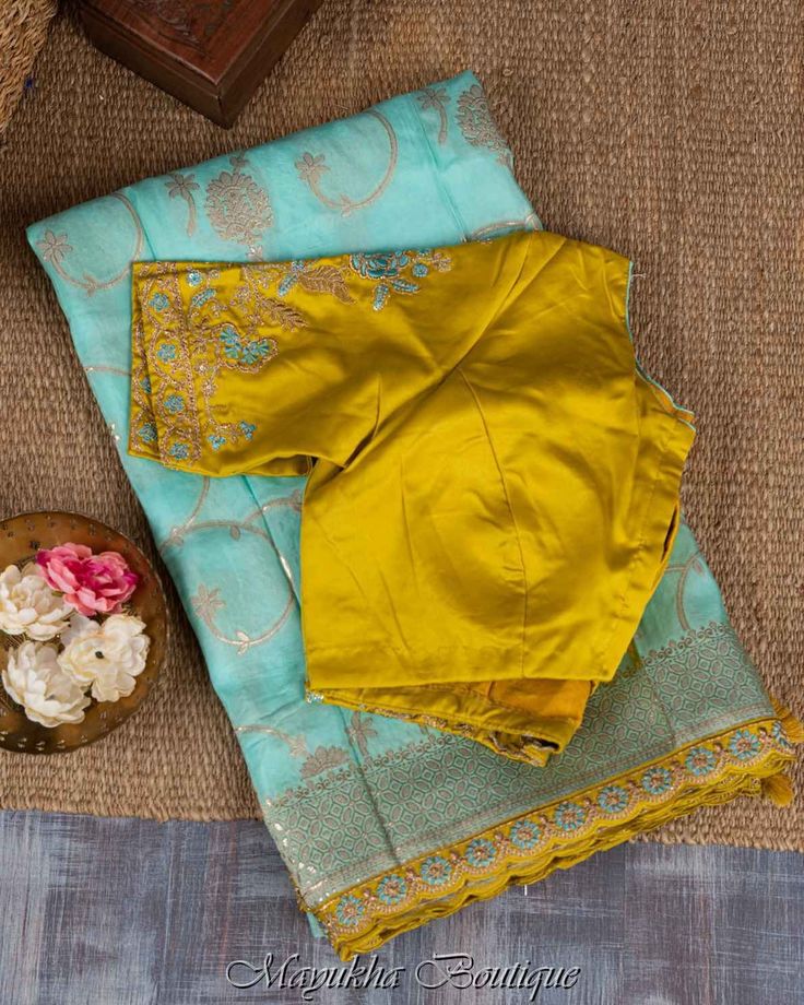 This Banarasi Blue Saree Is A Must-Have To Display The Most Opulent Apparel Style Of A Fashionable Persona. The Drape Has An Elegance That Never Goes Out Of Style Thanks To The Blue Base'S Shimmering Gold Zari Floral Jaal Tucked Into A Self Brocade Border, Which Is Bordered By A Yellow Scallop Embroidered Edge And Self Brocade Pallu. The Saree Is Paired With A Matching Yellow Blouse That Has Blue Piping Around The Neckline And Embroidery Hands. Features:Pure Dola Silk With Banarasi Jaal Work And Sky Blue Saree Contrast Blouse Silk, Blue Saree With Yellow Blouse, Gold Dola Silk Blouse With Dupatta, Designer Pista Green Blouse With Dupatta, Pista Green Chanderi Blouse With Dupatta, Pista Green Zari Work Blouse For Eid, Pista Green Blouse With Zari Work For Eid, Designer Tussar Silk Blouse With Dupatta, Pista Green Embroidered Blouse With Traditional Drape