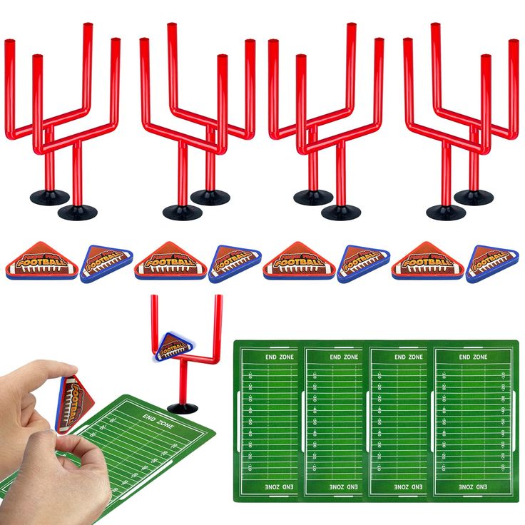 a hand is holding a game controller and several red plastic football goal posts with one person's finger pointing at it