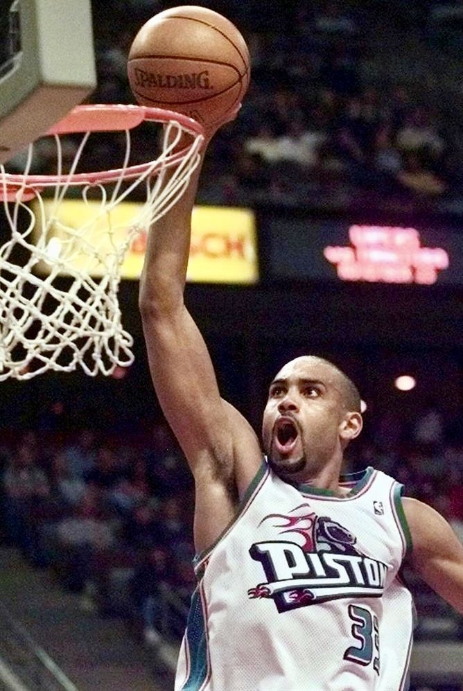 a basketball player dunking the ball into the hoop