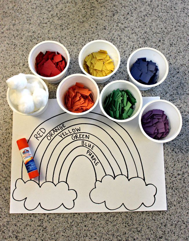 a table topped with bowls filled with different colored powders and paper cups on top of it