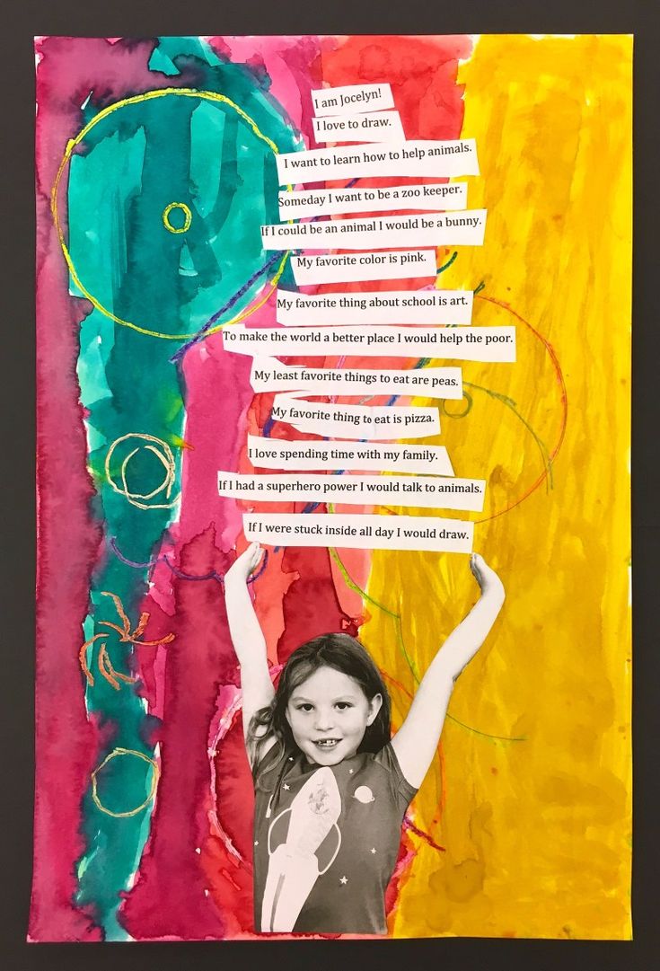 a child holding up a piece of paper with words written on it in different colors