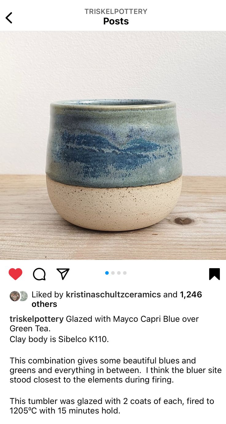 a blue and white bowl sitting on top of a wooden table