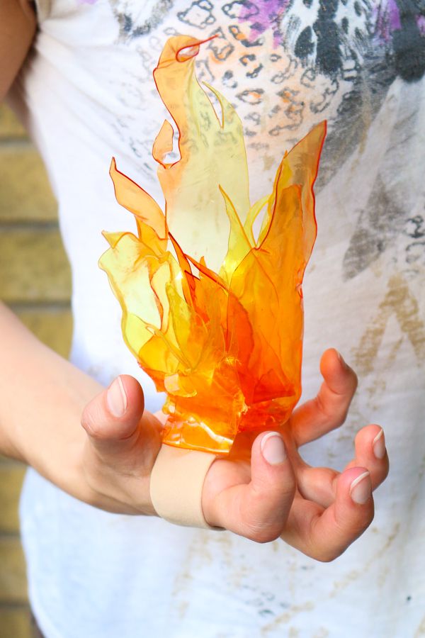 a woman is holding an orange object in her hands