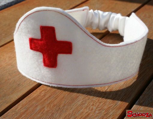 a white headband with a red cross on it and hearts in the middle, sitting on a wooden table