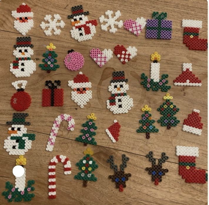 christmas decorations made out of perler beads on a wooden table