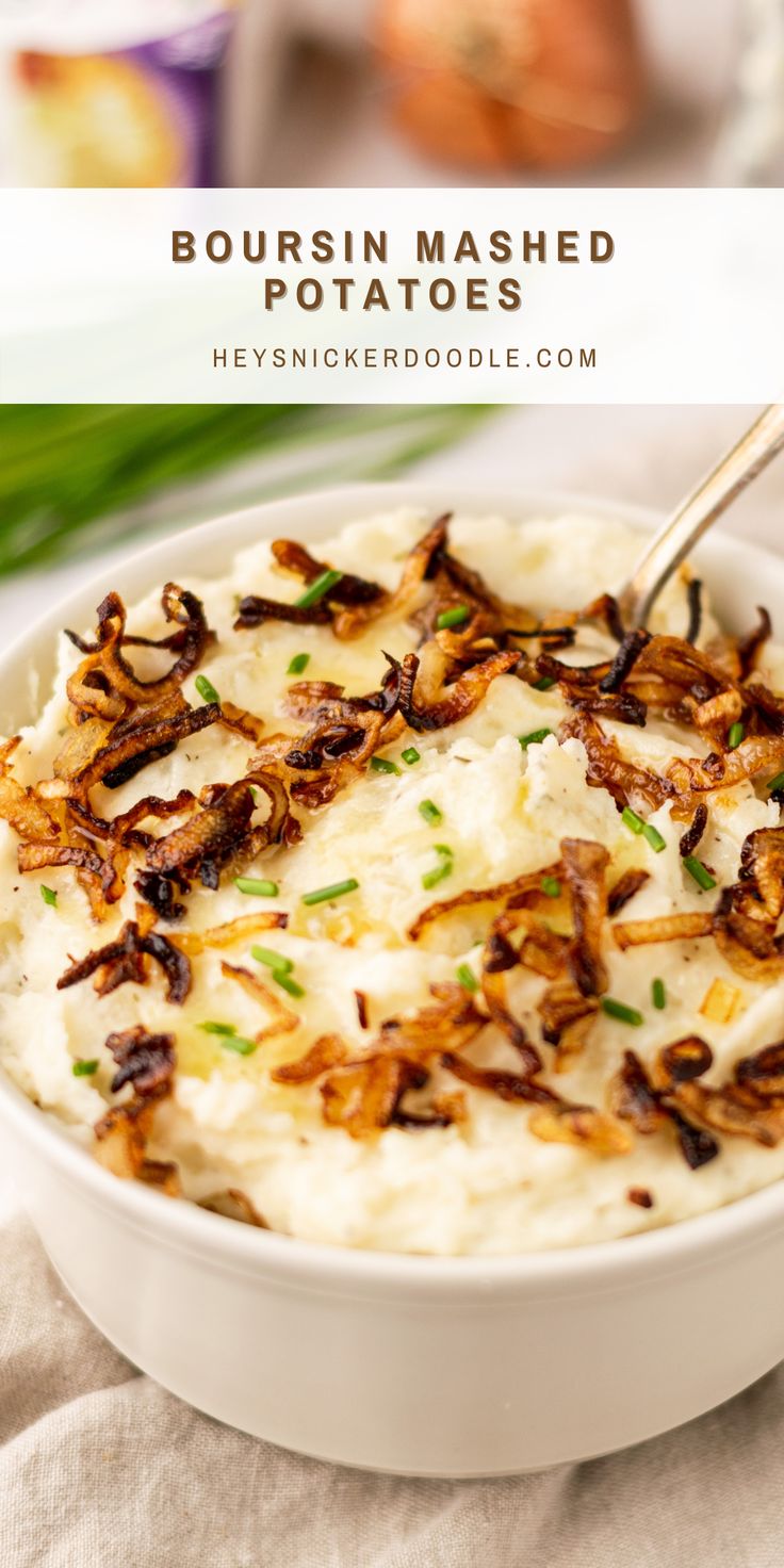 a bowl filled with mashed potatoes topped with green onions