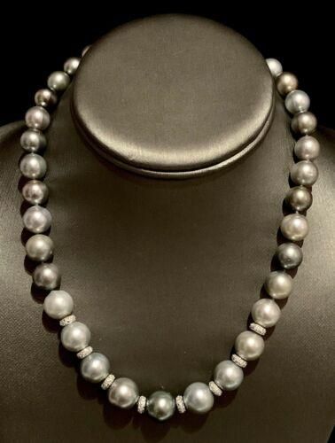 Diamond Tahitian Pearl Necklace 12.9 mm 18k Gold 17.25" Certified $12,500 821383 This fine piece of jewelry is designed by Ezra Kassin! DETAILS 18 KT SOLID WHITE GOLD CLASP (Clasp Stamped 750) 14 KT GOLD DIAMOND RONDELS 12.90-9.70 MM 17.25 Inches Number of Pearls: 35 Black Pearls Number of Diamonds: 84 Round Brilliant & Single Cut Diamonds (80 Single Cut Diamonds & 4 Round Brilliant Diamonds) 73.50 Grams Total Weight Quality Grade: AA (High) Color: Gray Overtone: Silver & Blue-Green Luxury Classic Diamond Necklace With Cushion Cut, Luxury Classic Cushion Cut Diamond Necklace, Luxury Single Strand Diamond Necklace, Luxury Tahitian Pearl Jewelry, Formal Diamond Necklaces With High Luster, Luxury Tahitian Pearl Jewelry With Diamond Accents, Luxury Tahitian Pearl Necklace, Luxury Tahitian Pearl Necklace In White Gold, Luxury Tahitian Pearl Necklace For Formal Occasions