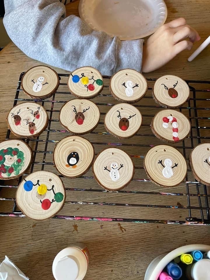 a child is painting wooden ornaments on a table