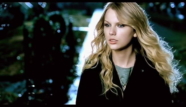 a woman with long blonde hair standing in the rain