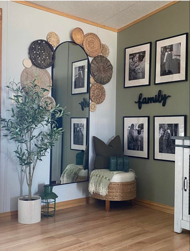 a living room with pictures on the wall and a bench in front of it,