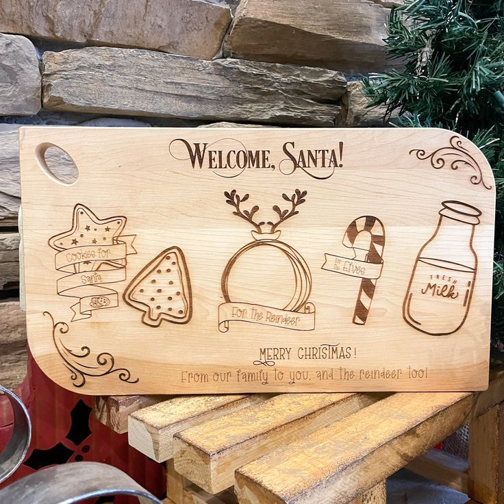 a wooden sign that says welcome santa with christmas decorations and candy canes on it