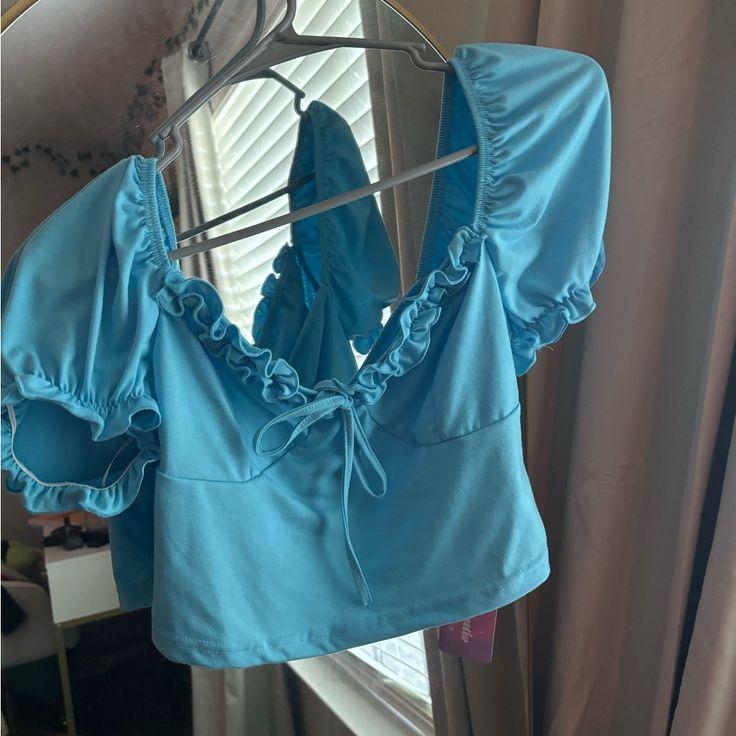 Blue Crop Top With Short Sleeves. Never Worn Blue Stretch Summer Tops, Blue Stretch Tops For Vacation, Trendy Blue Vacation Tops, Blue Stretch Tops For Day Out, Trendy Blue Tops For Day Out, Spring Blue Tops For Day Out, Blue Fitted Tops For Day Out, Fitted Light Blue Summer Top, Blue Crop Top