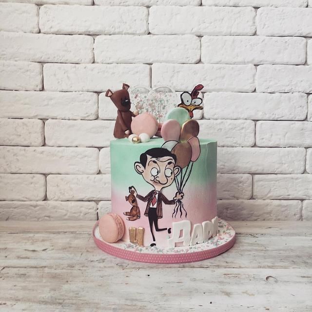 a birthday cake decorated with cartoon characters and balloons