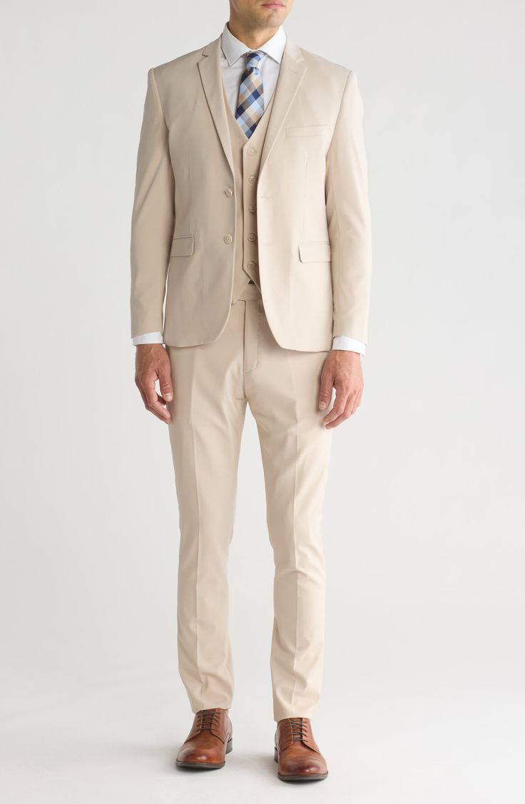 Stretch construction and a skinny cut mean modern appeal from a head-turning three-piece suit. Jacket has notched lapels; chest welt pocket; front welt pockets Vest has front button closure; V-neck Pants have zip fly with button closure; front slant pockets; back button-welt pockets Jacket and vest are lined; trousers are lined to the knee 62% polyester, 35% viscose, 3% spandex Dry clean Imported Each suit has a 6” drop, meaning that a size 38R jacket is paired with size 32 pants Slim Fit Three-piece Suit With Welt Pockets, Fitted Three-piece Tuxedo Suit With Pockets, Fitted Single Breasted Three-piece Suit With Notch Lapel, Slim Fit Suits With Welt Pockets And Lapel Collar, Beige Suits With Welt Pockets For Business Casual, Slim Fit Suits With Lapel Collar And Welt Pockets, Beige Business Casual Suits With Welt Pockets, Tailored Three-piece Suit With Notch Lapel, Business Casual Three-piece Suit With Lapel Collar