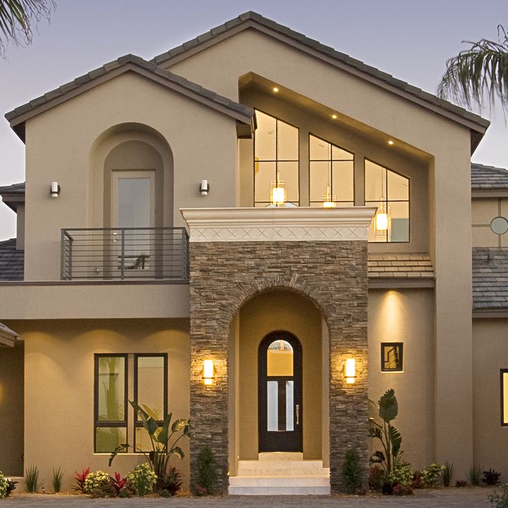 a house with lights on the front and side windows