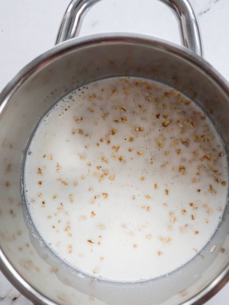 a metal pan filled with milk on top of a counter