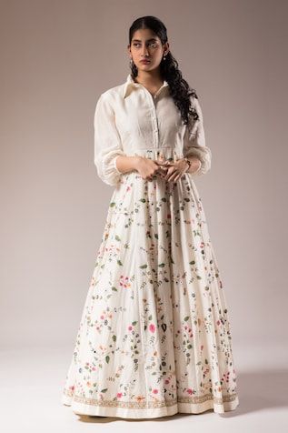 White silk chanderi anarkali featuring hand-painted floral motifs and dabka embroidery, Fit: Relaxed White Anarkali Dress In Cotton Silk, Embroidered Cotton Silk Floor-length Dress, Designer White Cotton Silk Dress, White Cotton Silk Dresses For Designer Wear, Designer Cotton Dress With Resham Embroidery, Cotton Dress With Resham Embroidery For Designer Wear, Bollywood Cotton Silk Dress With Printed Motifs, Transitional Cotton Dress With Resham Embroidery, Cotton Silk Straight Kurta With Printed Motifs