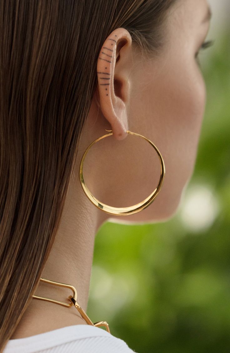 Crafted of recycled sterling silver and plated in 18-karat gold, these oversized hoops feature an organic sculptural design for a modern look. Style Name:Monica Vinader Deia Hoop Earrings. Style Number: 6203971. Available in stores. Modern Gold Sculptural Jewelry, Modern Sculptural Jewelry With Polished Finish, Modern Sculptural Gold Jewelry, Contemporary Sculptural Gold Jewelry, Modern Hoop Earrings In Recycled Gold, Modern Small Hoop Earrings In Recycled Gold, Modern Polished Brass Hoop Earrings, Modern Hoop Jewelry With Shiny Finish, Modern Hand Forged Hoop Earrings