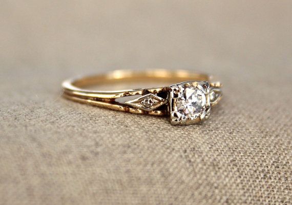 a close up of a diamond ring on a cloth