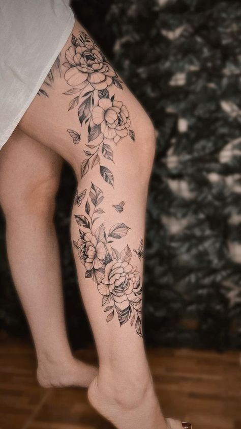 a woman's leg with flowers on it