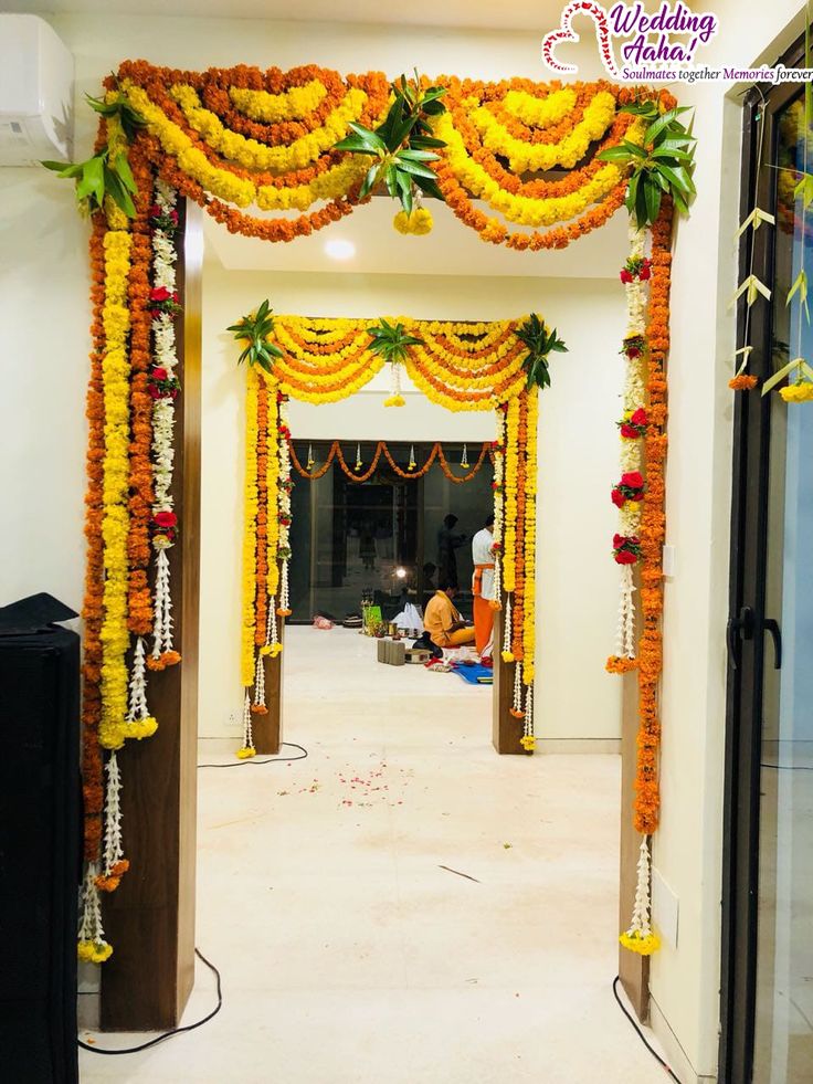 an entrance decorated with flowers and garlands