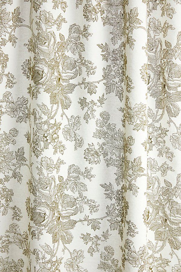 a close up view of a white and gold curtain