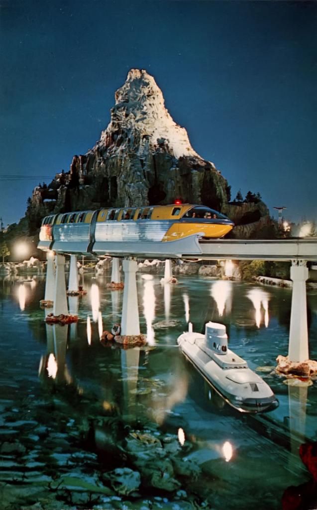 a boat is floating on the water near a bridge with mountains in the background at night