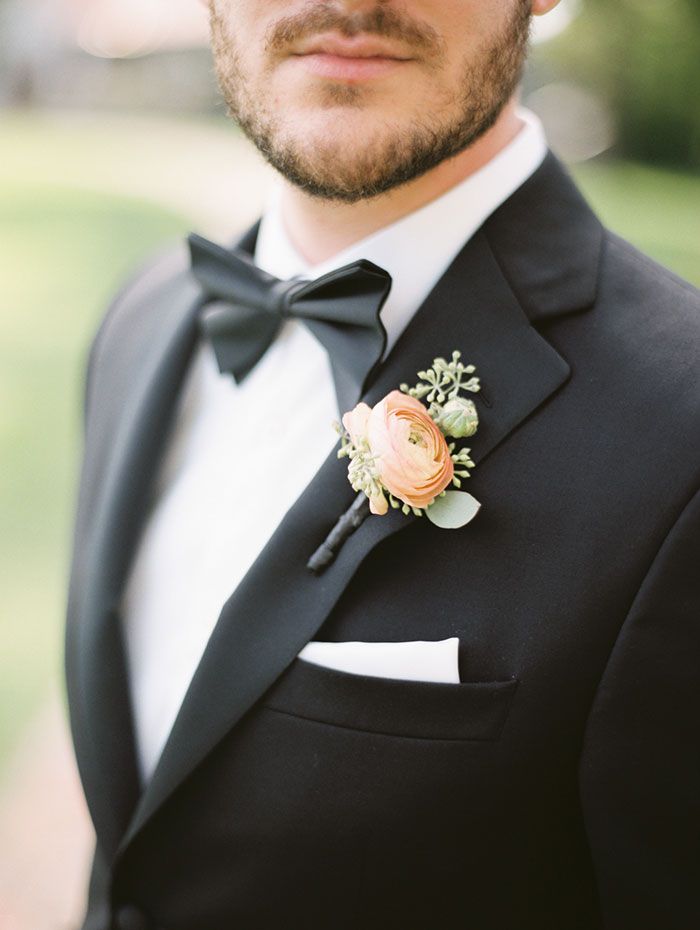 a man in a tuxedo with a boutonniere on his lapel