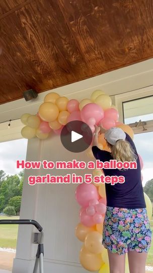 a woman standing in front of a balloon arch with the words how to make a balloon garland in 5 steps