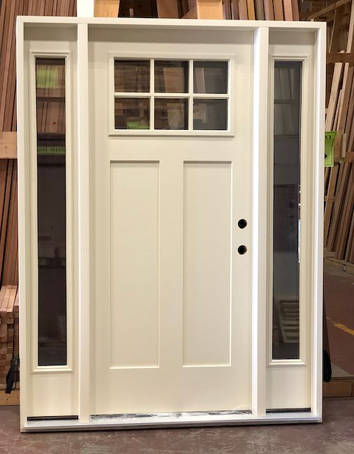 a white front door with glass panels on the sides and side windows in between them