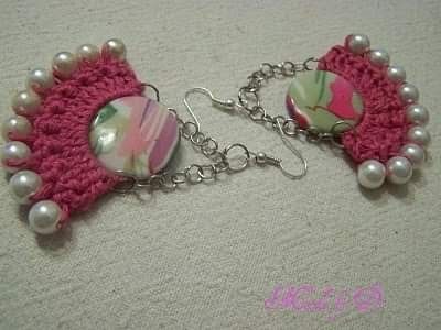 two pieces of pink and white crocheted fabric with pearls attached to chain bracelets