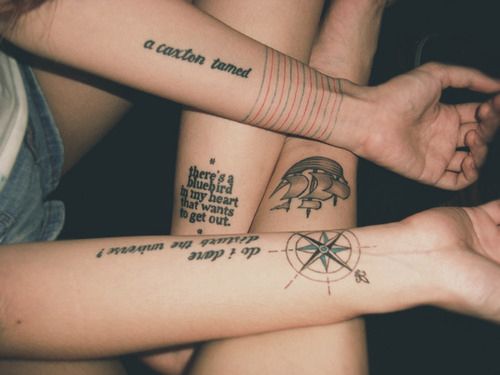 two people with matching tattoos on their arms