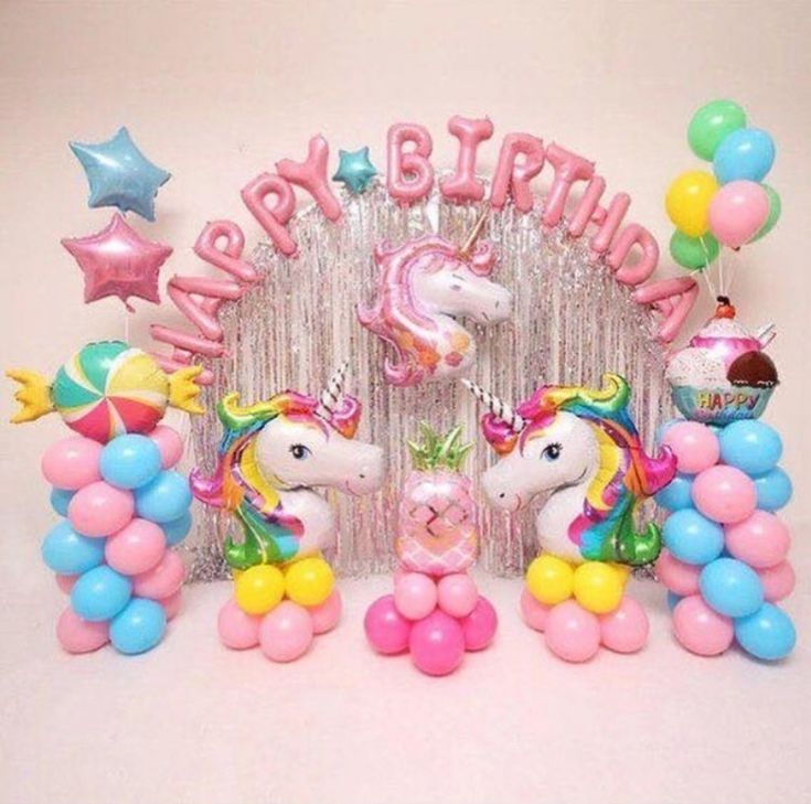 a birthday party with balloons and unicorns