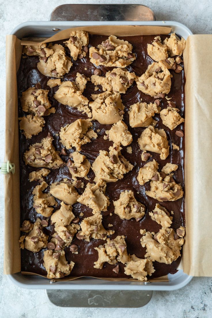 a pan filled with chocolate and cookies on top of a table