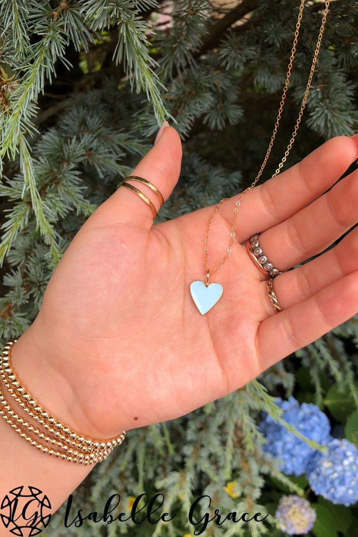 The color of summer shines bright in our Baby Blue Enamel Heart Necklace. A gorgeous and colorful addition to your collection. A beautiful enamel gold plated heart charm sparkles on a 14kt gold fill chain. Order your homemade necklace here.