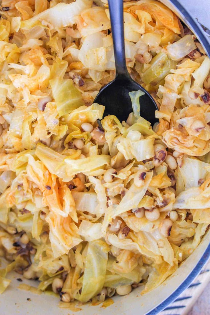 a bowl filled with cabbage and nuts on top of a table