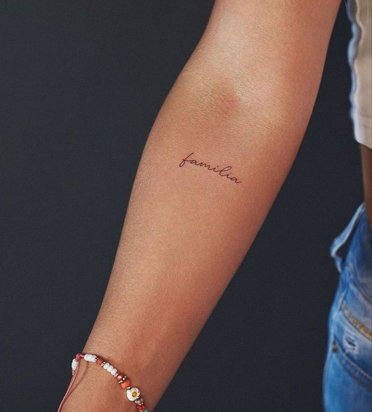 a woman's arm with a tattoo on it that reads, name janelle