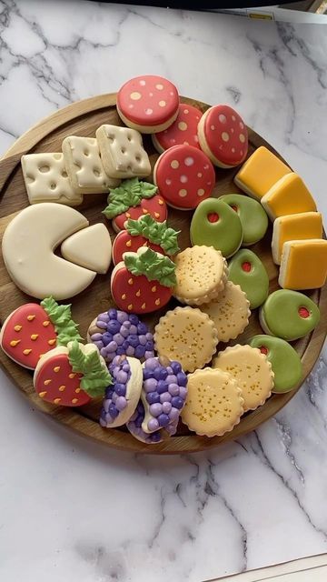 a wooden plate topped with lots of different types of cookies