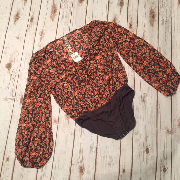 Free People Floral Bodysuit. Size Is Xs But Will Fit More Form Fitting If You Normally Wear A Medium Or A Large And Even Still Will Have Room. Snap Closure On Bottom, Tie Closure On Chest. Looks Great In Jeans!!! Purchased At Lord & Taylor And Just Never Got Around To Wearing This Beautiful Top!!! Fall Cotton Bodysuit, Printed Fitted Cotton Bodysuit, Casual One-piece Floral Print Bodysuit, Fitted Floral Print One-piece Bodysuit, Floral Print Fitted Bodysuit, Fitted Floral Print Bodysuit, Spring Long Sleeve Printed Bodysuit, Fitted Long Sleeve Bodysuit With Floral Print, Casual Floral Print One-piece Bodysuit