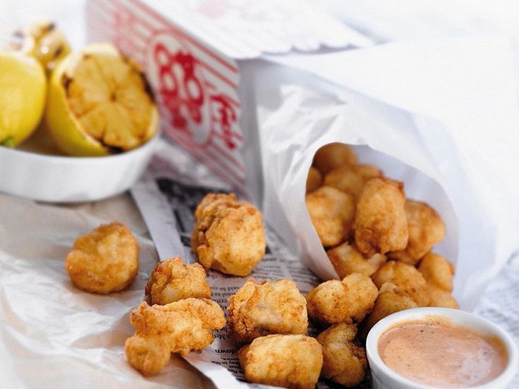 some fried food is next to a bowl of dipping sauce